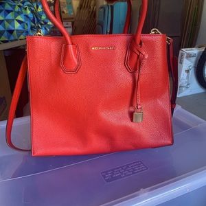 Red Michael Kors bag with shoulder strap